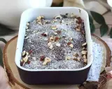 Pyszny brownie z mikrofali, posypany cukrem pudrem i orzechami, w białej ceramicznej formie.