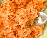 Tarta marchewka z majonezem, idealna jako surówka do obiadu. Widoczna łyżka widelca zagłębia się w pomarańczową masę.